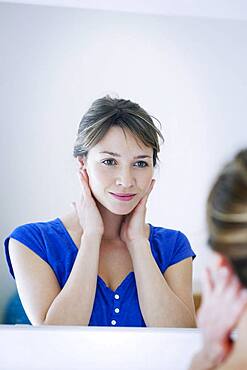 Woman looking in a mirror.