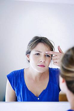 Woman looking in a mirror.