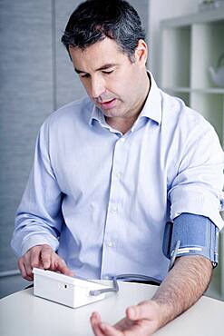 Man measuring his blood pressure.