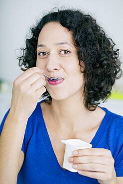 Woman eating yogurt.