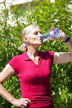 Elderly person with cold drink