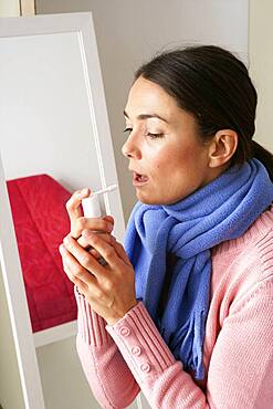 Woman using spray in mouth