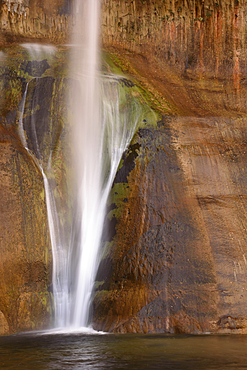 Lower Calf Creek Falls drops down a sandstone rock face in Grand Staircase - Escalante National Monument, Utah.