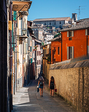 The view of St. Lorenzo's Cathedral from an alley with two people walking, Perugia, Umbria, Italy, Europe