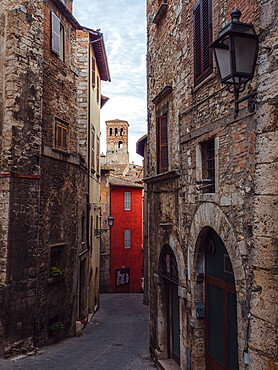 A typical medieval alley in Narni's old town, with a view of the bell tower of the Cathedral, Narni, Umbria, Italy, Europe