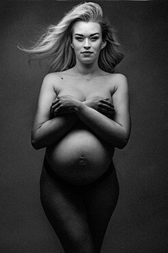 Artistic shot of a pregnant woman in a studio, United Kingdom, Europe