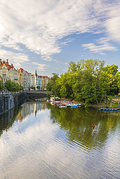 Art nouveau buildings along Vltava River and boats at Slovansky island, Prague, Czech Republic (Czechia), Europe