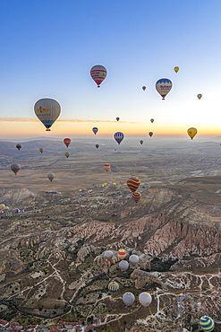 Aerial view of Cavusin and hot air balloons at dawn, Avanos District, Nevsehir Province, Cappadocia, Central Anatolia Region, Anatolia, Turkey, Asia Minor, Asia