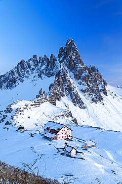 Dusk on Locatelli mountain hut with Paterno mountain in the background, winter view, Tre Cime di Lavaredo (Lavaredo peaks), Sesto (Sexten), Dolomites, South Tyrol, Italy, Europe