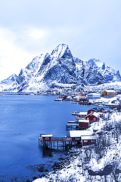 Dusk over the traditional fishing village of Reine after snowfall, Reine, Lofoten Islands, Norway, Scandinavia, Europe