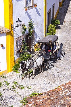 Europe, Portugal, Obidos. April 16, 2022. Tourist in a horse drawn wagon in Obidos.