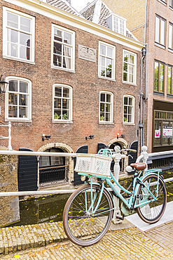 Europe, Netherlands, South Holland, Delft. April 25, 2022. Bicycle parked along a canal in Delft.