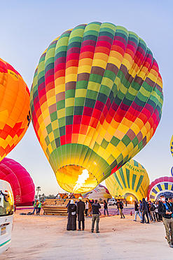 Luxor, Egypt. February 26, 2022. Hot air balloons being prepared for tourist rides at sunrise in Luxor.