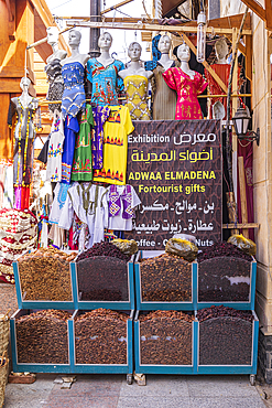 Thebes, Luxor, Egypt. February 24, 2022. Dried hibiscus and dates and women's dresses at a market in Luxor.