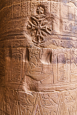 Agilkia Island, Aswan, Egypt. Christian cross carved over Egyptian hieroglyphics on a column at the Philae Temple, a UNESCO World Heritage Site.