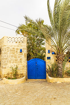 Faiyum, Egypt. Blue gate in a stone wall in Egypt.