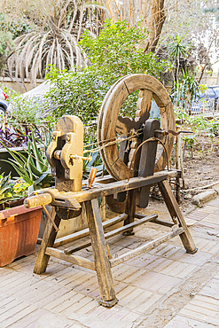 Old Cairo, Cairo, Egypt. An antique wooden spinning wheel.