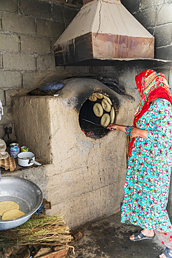 Margib, Sughd Province, Tajikistan. August 15, 2021. Baking flat bread in a wood fired oven. Editorial Use Only