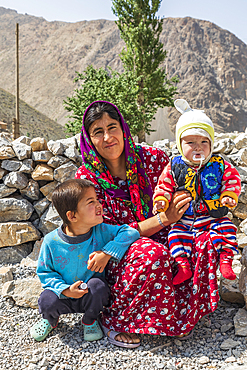 Haft Kul, Sughd Province, Tajikistan. August 17, 2021. A woman with her two children in the mountains of Tajikistan. Editorial Use Only