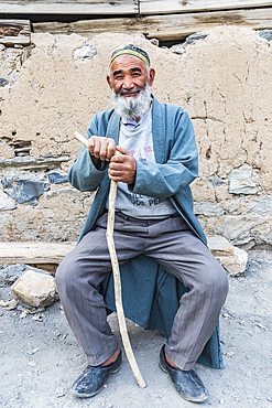 Haft Kul, Sughd Province, Tajikistan. August 17, 2021. Man in a long coat, with a walking stick in a mountain village. Editorial Use Only