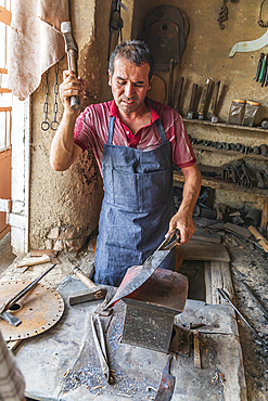 Istaravshan, Sughd Province, Tajikistan. August 19, 2021. Blacksmith hammering hot metal in Istaravshan. Editorial Use Only