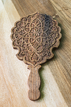 Istaravshan, Sughd Province, Tajikistan. August 19, 2021. Hand carved wooden hand held mirror. Editorial Use Only