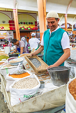 Khujand, Sughd Province, Tajikistan. August 20, 2021. Vendor cleaning dried beans at the Panjshanbe Bazaar in Khujand. Editorial Use Only