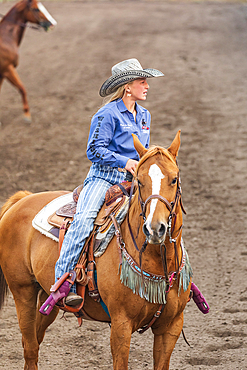 USA, Washington State, Whitman County. Palouse. Palouse Empire State Fair. Colfax. September 9, 2021. Woman on a horse at a rodeo.