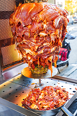 Jackson Heights, Queens, New York City, New York, USA. Gyro meat being prepared for cooking.