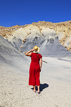 A girl admiring the beautiful rock formations in Big Water area during a summer day, Utah, United States of America, North America