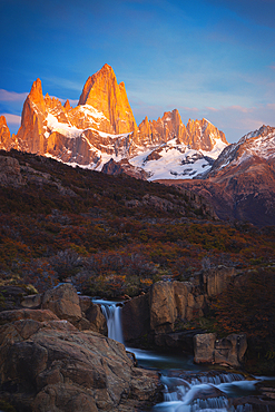 Escondida waterfall and Fitz Roy mountain in the background during sunrise, El Chalten, Parque Nacional Los Glaciares, Santa Cruz, Patagonia Argentina, Argentina, South America