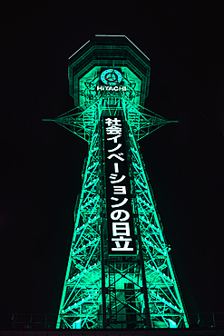 Osaka Tsutenkaku tower in the Shinsekai district. Illuminated green night lights. Japan