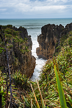 Vertical View of Towering Limestone Cliffs and Deep Ocean Channel at Punakaiki, West Coast, South Island