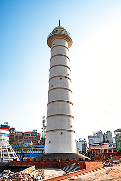 The newly reconstructed Dharahara Tower rises tall against a clear blue sky in central Kathmandu