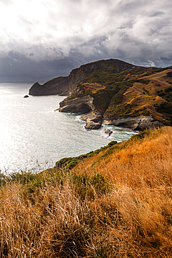 Golden headlands and dramatic cliffs dropping into the sea at Cape Farewell, Golden Bay, South Island, New Zealand.