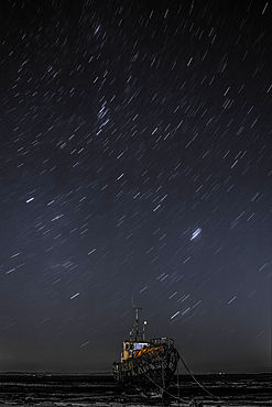 Star trails above the derelict trawler Vita Nova, from the Cumbrian Coast, Furness Peninsula, Cumbria, England, United Kingdom, Europe