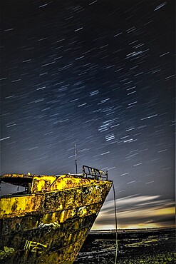 Star trails above the derelict trawler Vita Nova, from the Cumbrian Coast, Furness Peninsula, Cumbria, England, United Kingdom, Europe