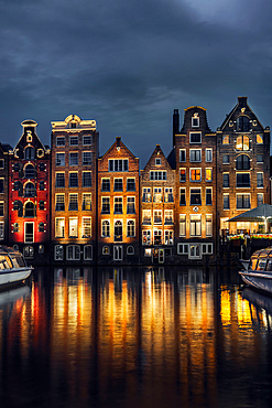 Night dancing houses at Amsterdam Canal Damrak, Amsterdam, Holland, Netherlands, Europe