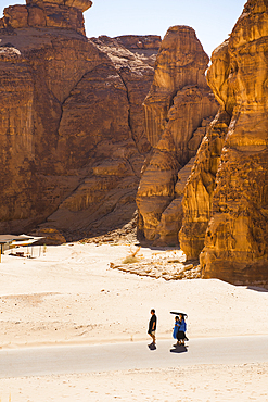 People walking within Our Habitas AlUla, a sustainable desert luxury resort nestled within an ancient oasis in the desert canyons of the Ashar Valley, Medina Province, Saudi Arabia, Middle East