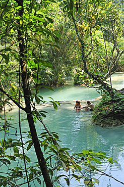 Couple bathing at Kuang Si waterfalls, Luang Prabang, Laos, Southeast Asia