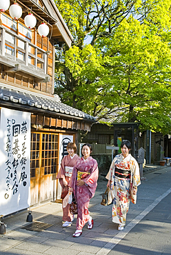 Three young women wearing traditional kimono in Oharai-machi Historic District, Ise, Mie prefecture, Japan