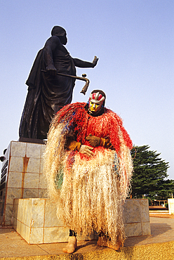 Egungun in front of the statue of King Behanzin who resist to french colonialism,Abomey,Benin,