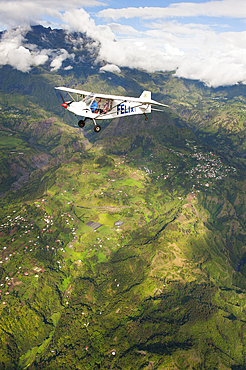 Aerial view of an ULM (Ultralight aviation) flying above the northwestern coast, Reunion island, overseas departement of France, Indian Ocean