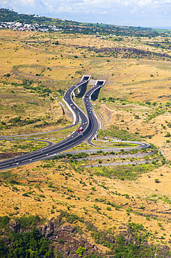 Aerial view over the 'Route des Tamarins' and the tunnel, the highway N1 on the west coast near Saint-Paul, Reunion island, overseas departement of France,Indian Ocean