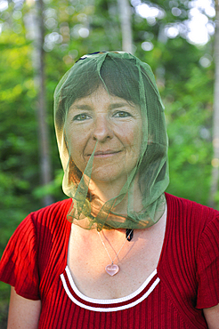 Woman wearing a mosquito net on her head, Saguenay region, Province of Quebec, Canada, North America