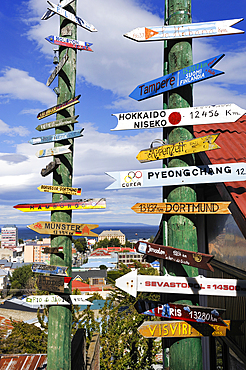 Sign post showing distance of some cities across the world from Punta Arenas, Strait of Magellan, Peninsula of Brunswick, Chile, South America