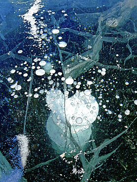 Methane and air bubbles caught in the ice when the lake froze, Lake Baikal, Russia.