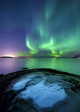 Aurora Borealis over Vagsfjorden outside of Harstad in Northern Norway. Auroras are the result of the emissions of photons in the Earth's upper atmosphere.