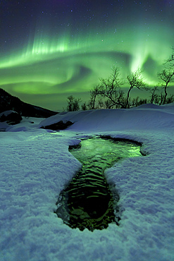 Aurora Borealis over a frozen river, Klubbfjellet Mountain, Nordland, Norway.