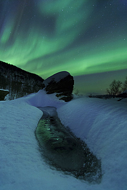 Aurora Borealis over a frozen river, Klubbfjellet Mountain, Nordland, Norway.
